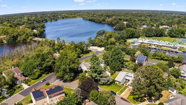 an aerial view of residential house with outdoor space and lake view