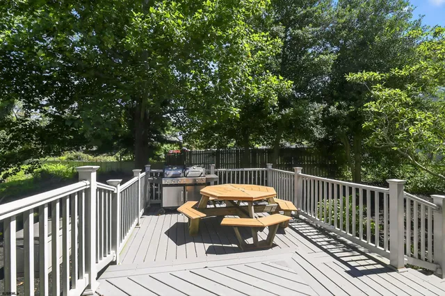 a view of a balcony with wooden floor and fence