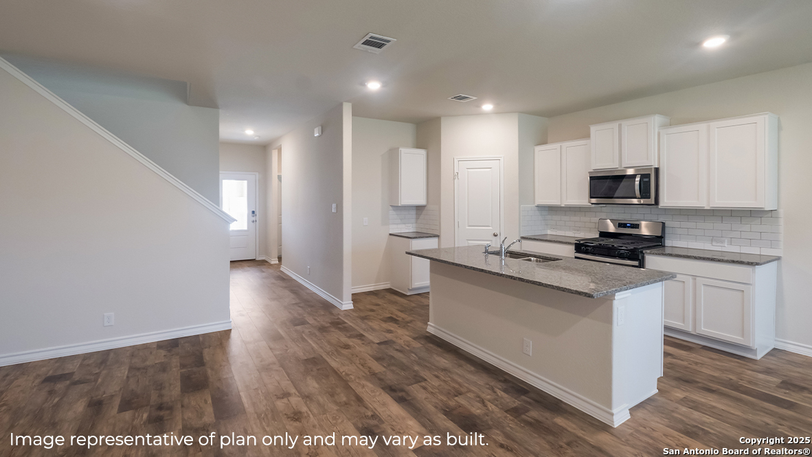 116 Hazel Peak Boerne, TX 78006 - Photo 7 of 31 a kitchen with granite countertop a stove a sink and a refrigerator