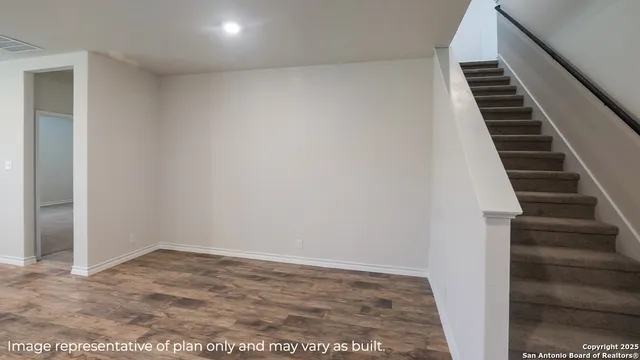 a view of an empty room with stairs