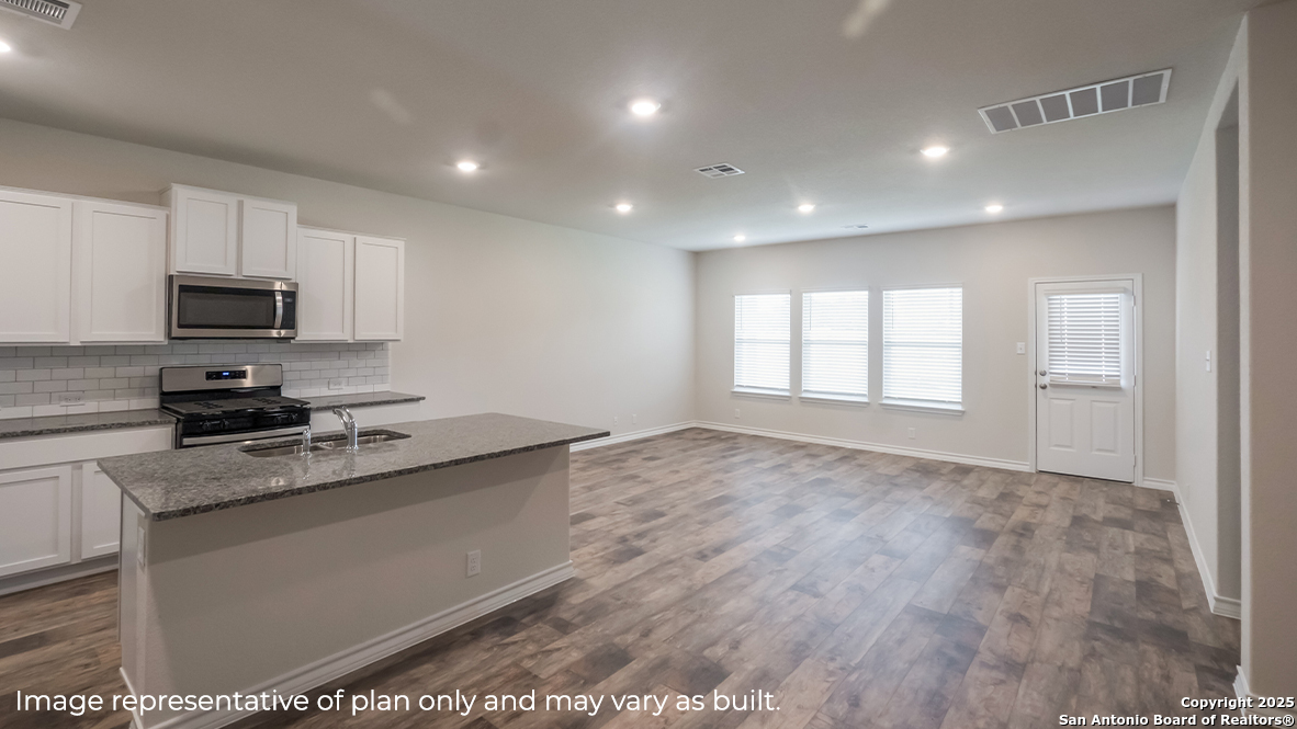 116 Hazel Peak Boerne, TX 78006 - Photo 10 of 31 a kitchen with granite countertop a sink stainless steel appliances and white cabinets