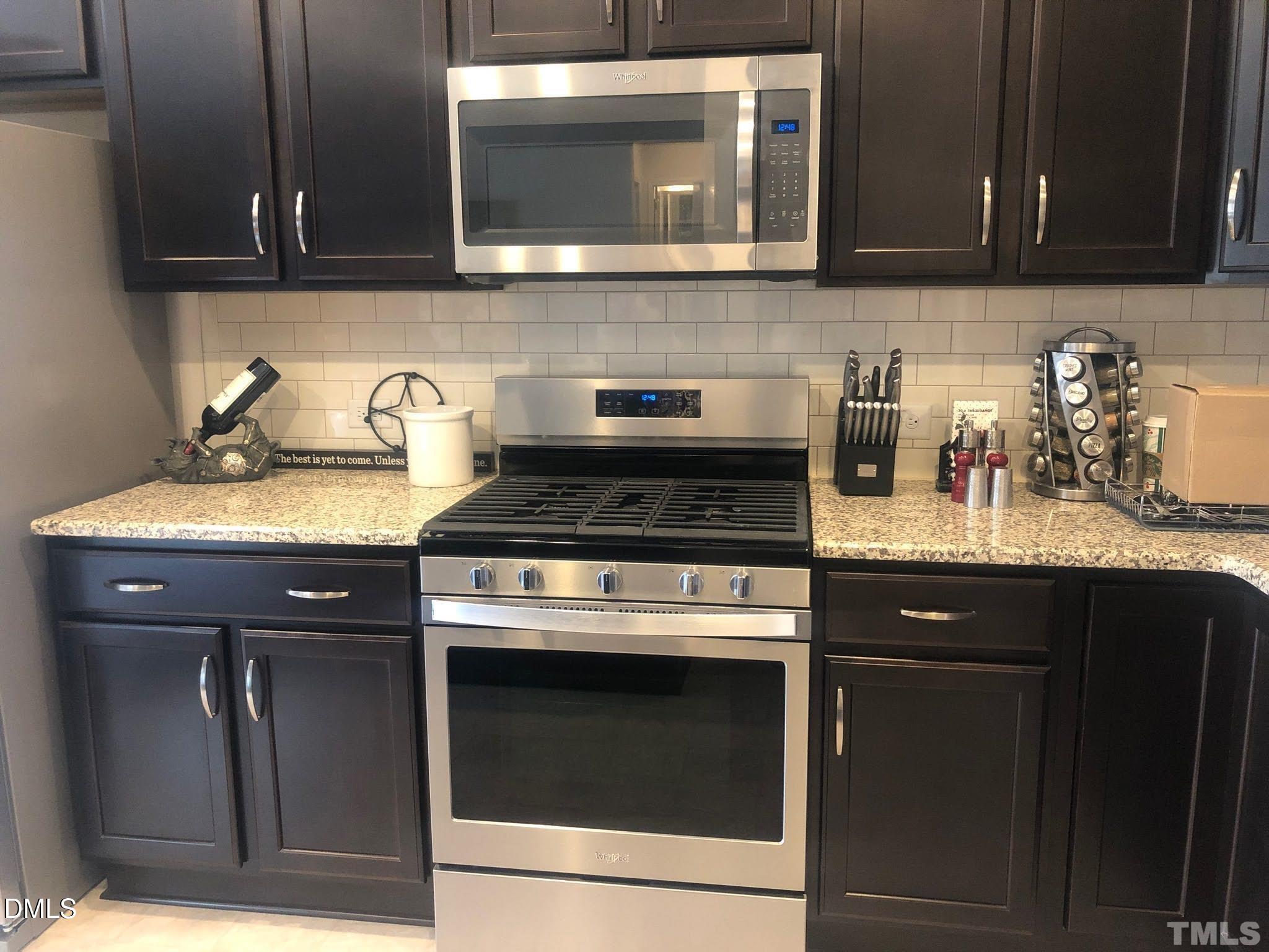 2613 Lacebark Pine Road Raleigh, NC 27616 - Photo 6 of 15 a kitchen with granite countertop a stove and a sink