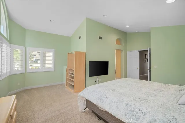 a bedroom with a bed and a television in it