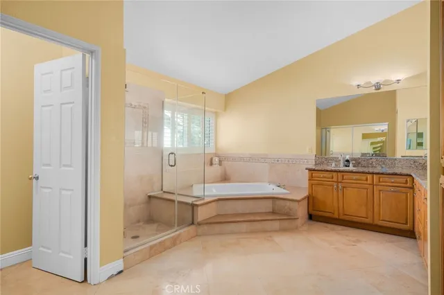 a spacious bathroom with a tub shower and sink