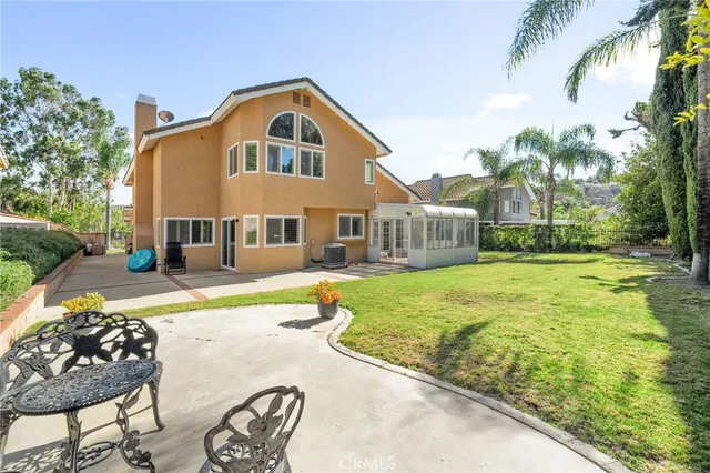 a front view of a house with swimming pool having outdoor seating