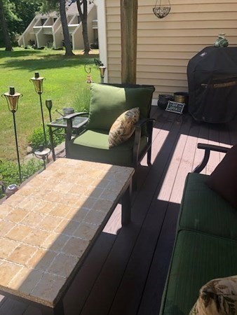 35 Hazen Road, Unit F3 Shirley, MA 01464 - Photo 13 of 22 a view of a patio with lawn chairs floor to ceiling window and yard