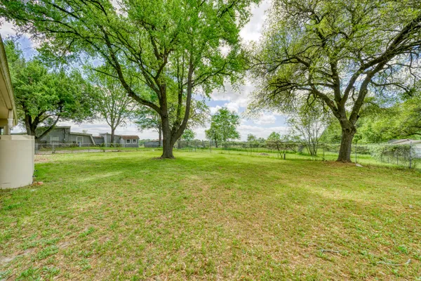 a view of a garden with lawn chairs