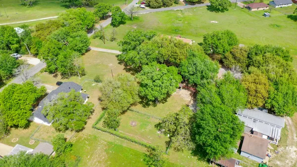 an aerial view of a residential houses with outdoor space