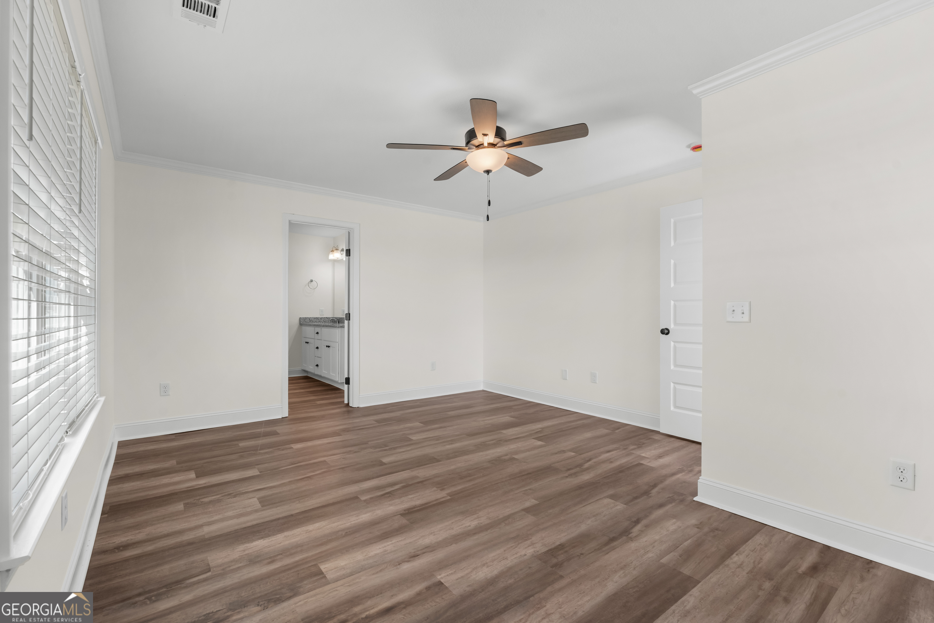 919 Ryegrass Road Statesboro, GA 30458 - Photo 11 of 20 wooden floor in an empty room with a window