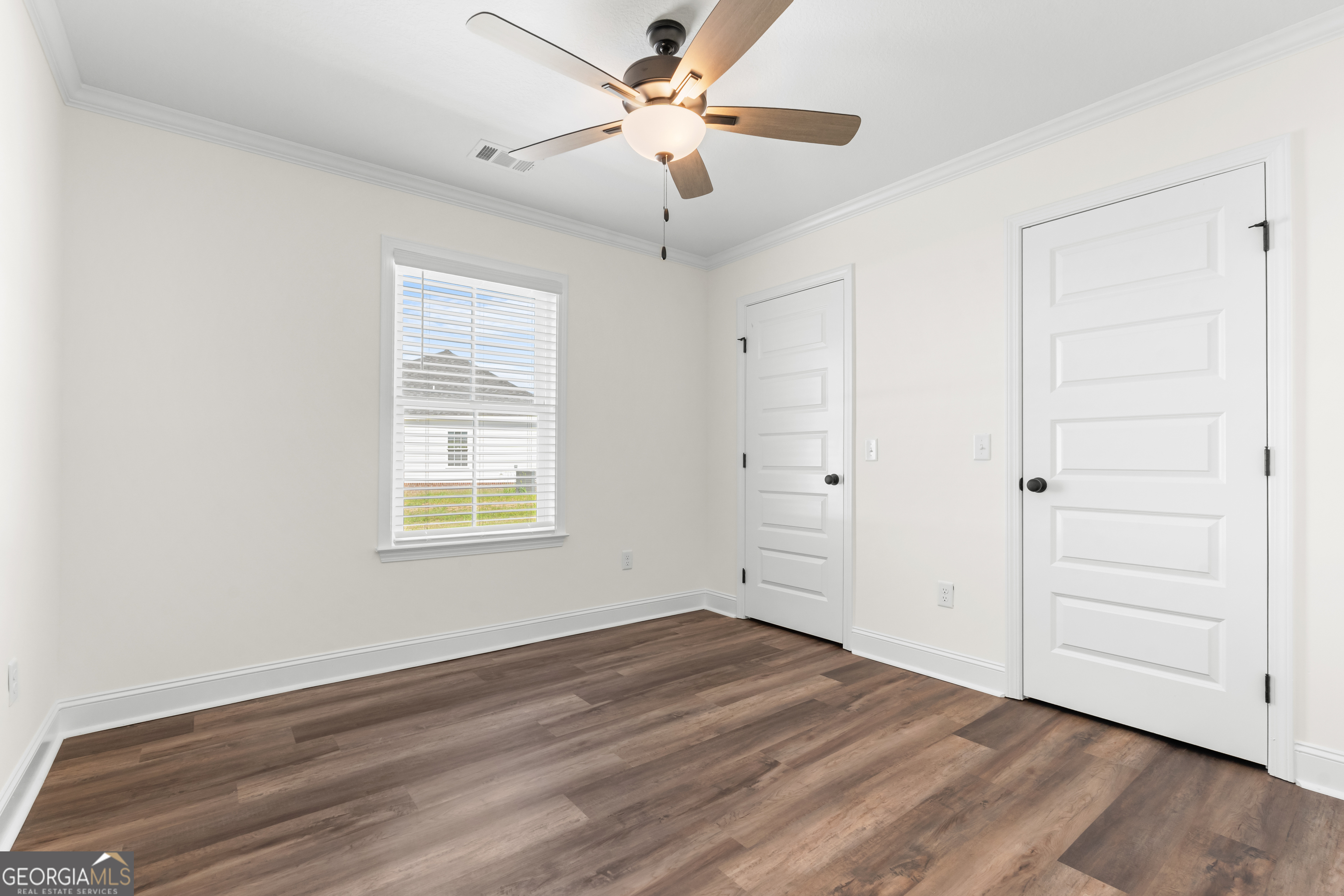 919 Ryegrass Road Statesboro, GA 30458 - Photo 14 of 20 a view of an empty room with wooden floor and a window