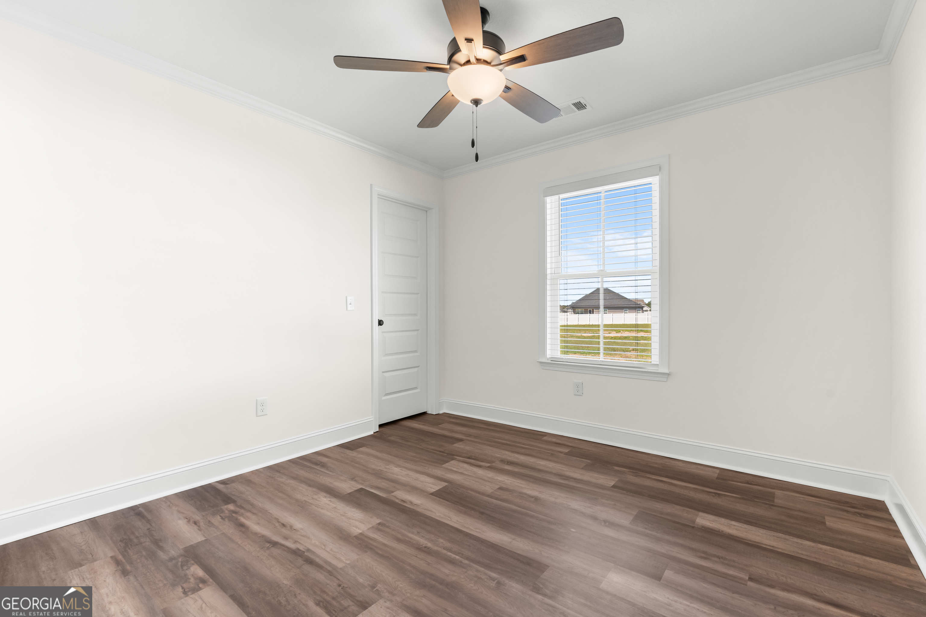 919 Ryegrass Road Statesboro, GA 30458 - Photo 16 of 20 an empty room with a window and a ceiling fan