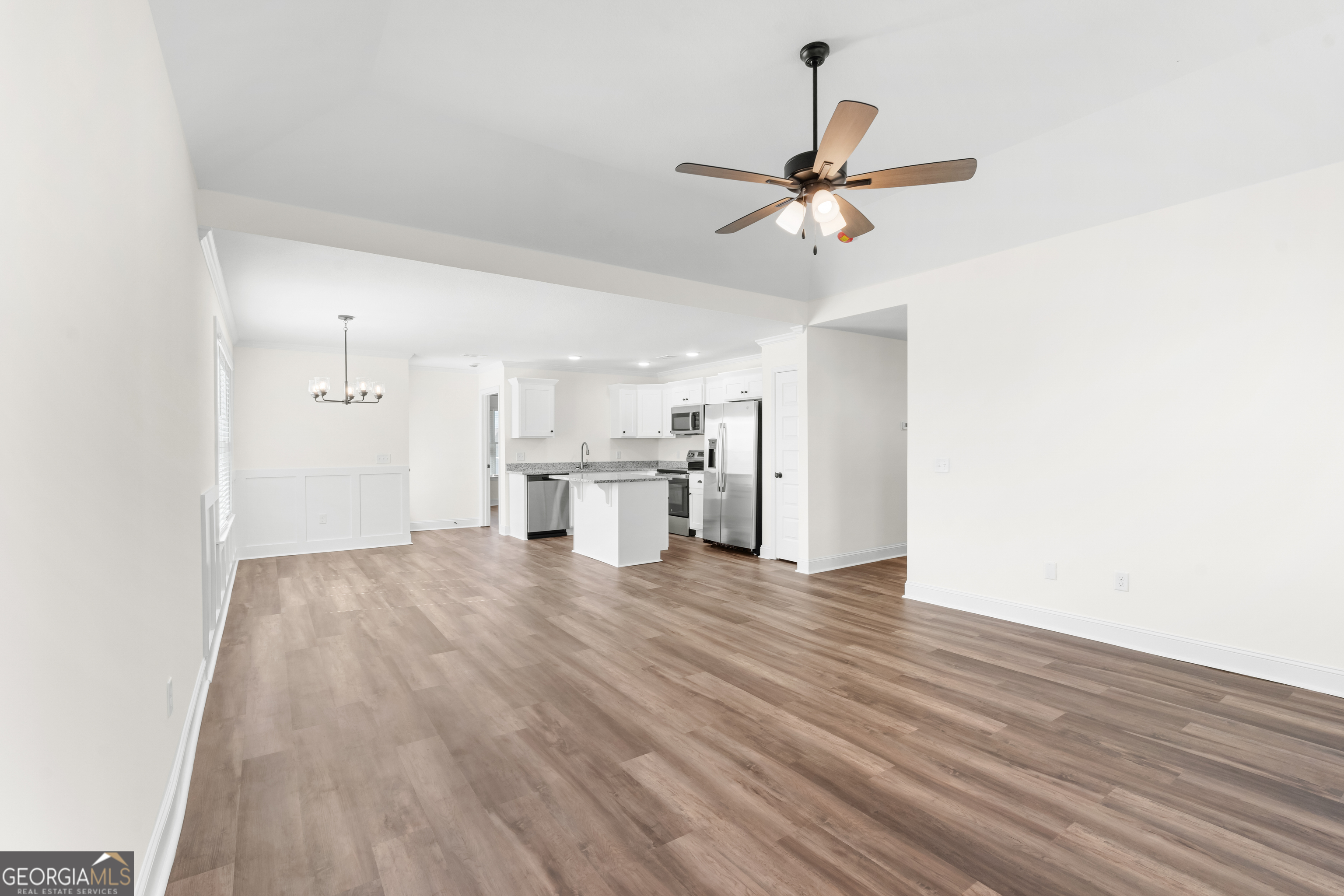 919 Ryegrass Road Statesboro, GA 30458 - Photo 4 of 20 a view of a kitchen with a sink and cabinet with wooden floor