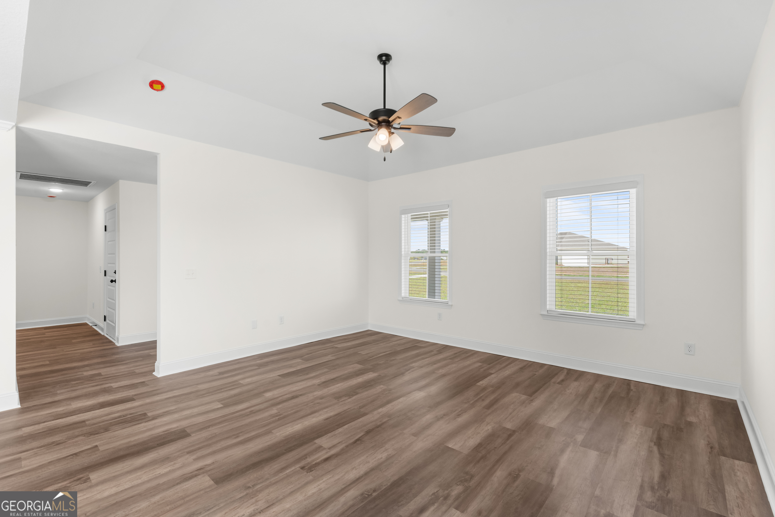 919 Ryegrass Road Statesboro, GA 30458 - Photo 5 of 20 wooden floor in an empty room with a window