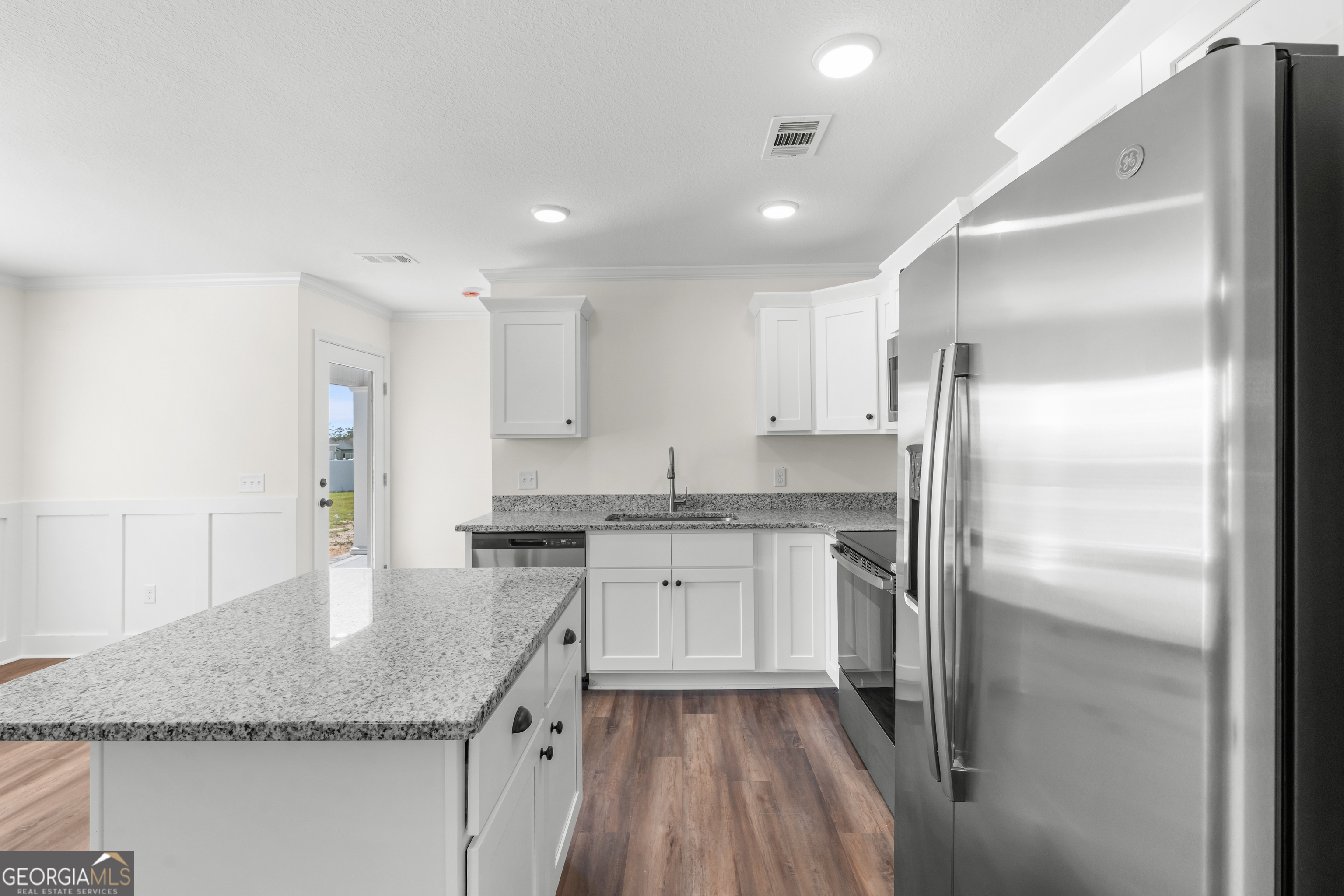 919 Ryegrass Road Statesboro, GA 30458 - Photo 8 of 20 a kitchen with stainless steel appliances granite countertop a sink stove and refrigerator