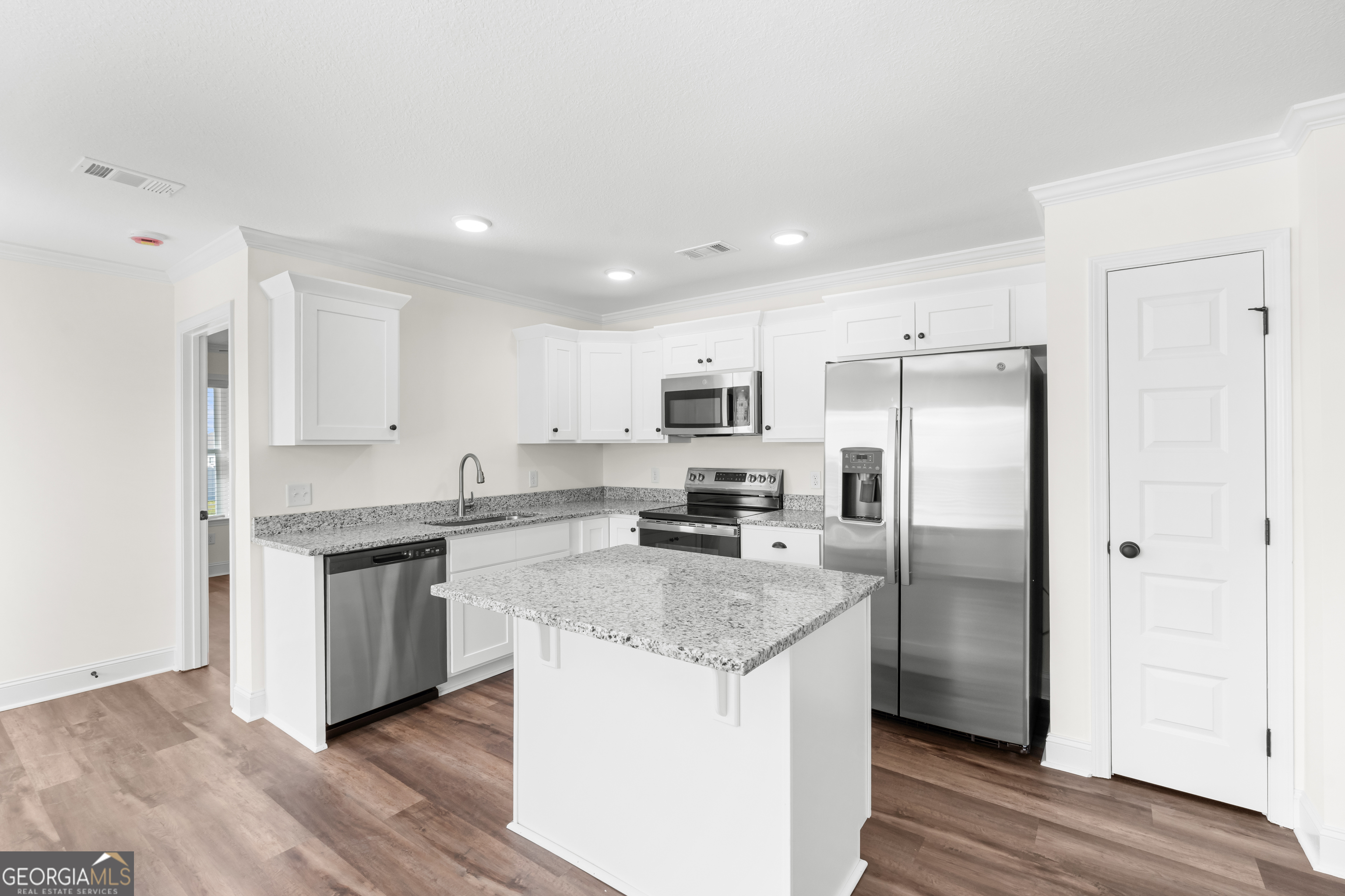 919 Ryegrass Road Statesboro, GA 30458 - Photo 9 of 20 a kitchen with stainless steel appliances granite countertop a refrigerator a sink and a stove