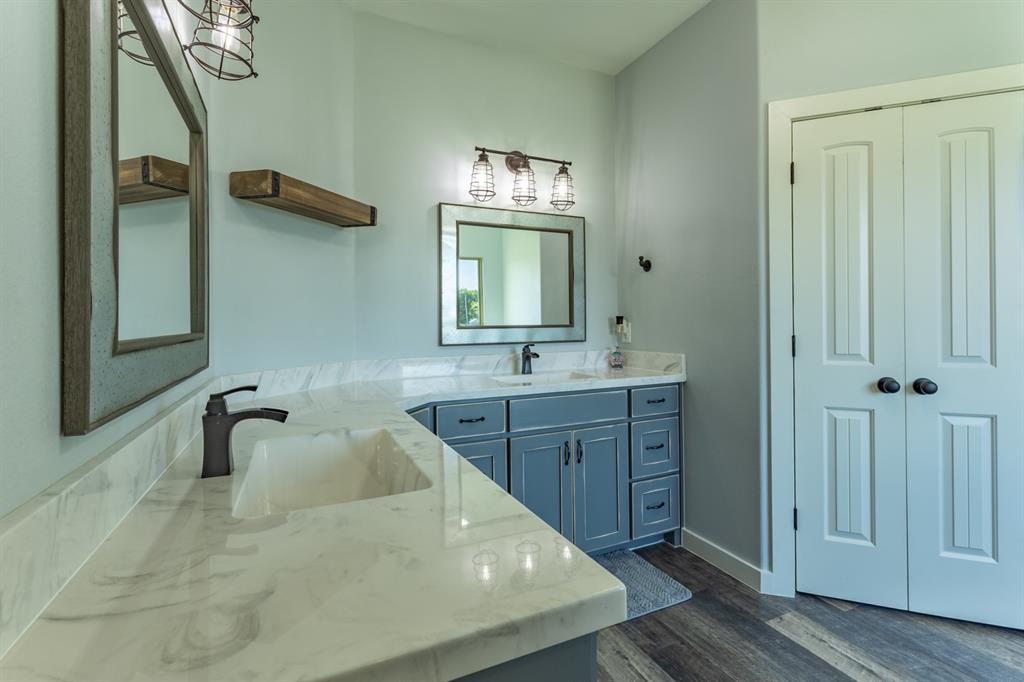 14910 Old Stoney Road Ponder, TX 76259 - Photo 20 of 36 a bathroom with a tub sink and mirror