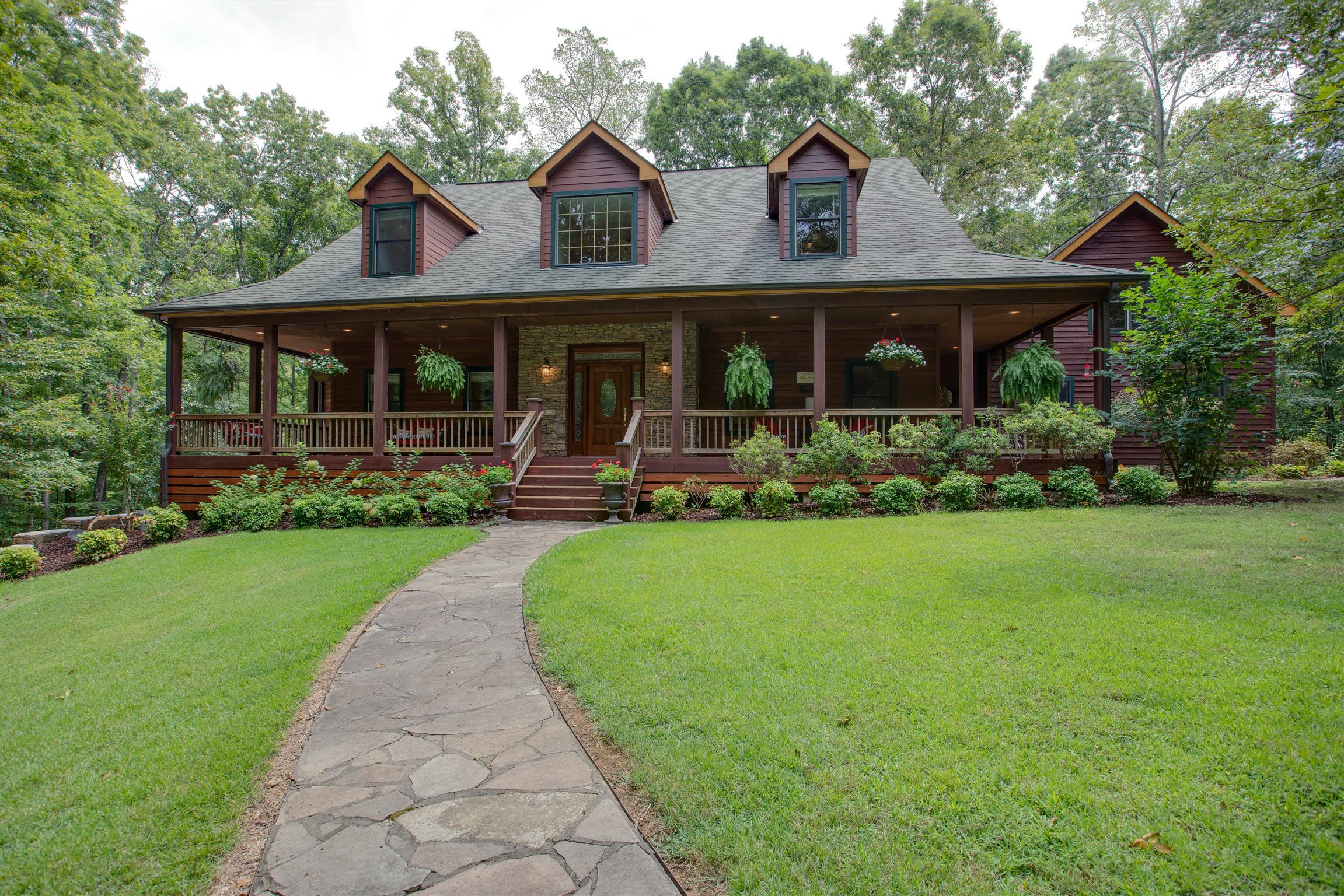 5745 Pinewood Road Franklin, TN 37064 - Photo 1 of 27 a front view of a house with garden