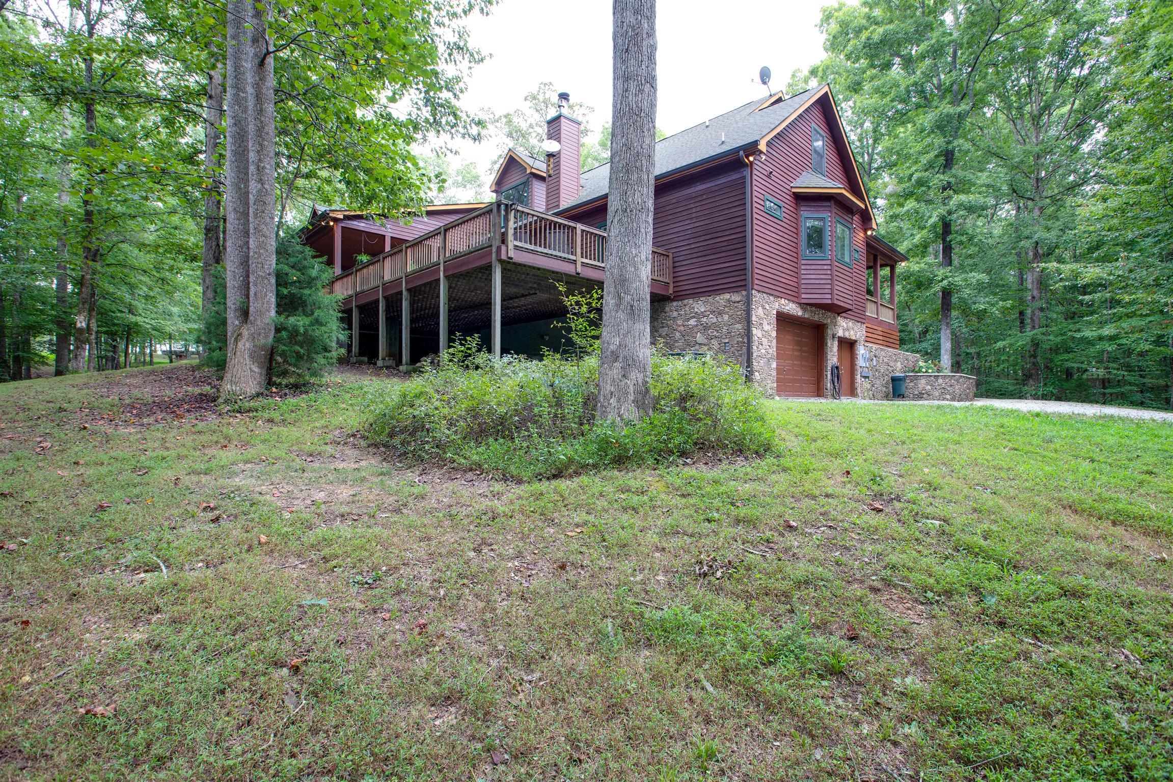 5745 Pinewood Road Franklin, TN 37064 - Photo 21 of 27 a view of a big house with a big yard and large trees