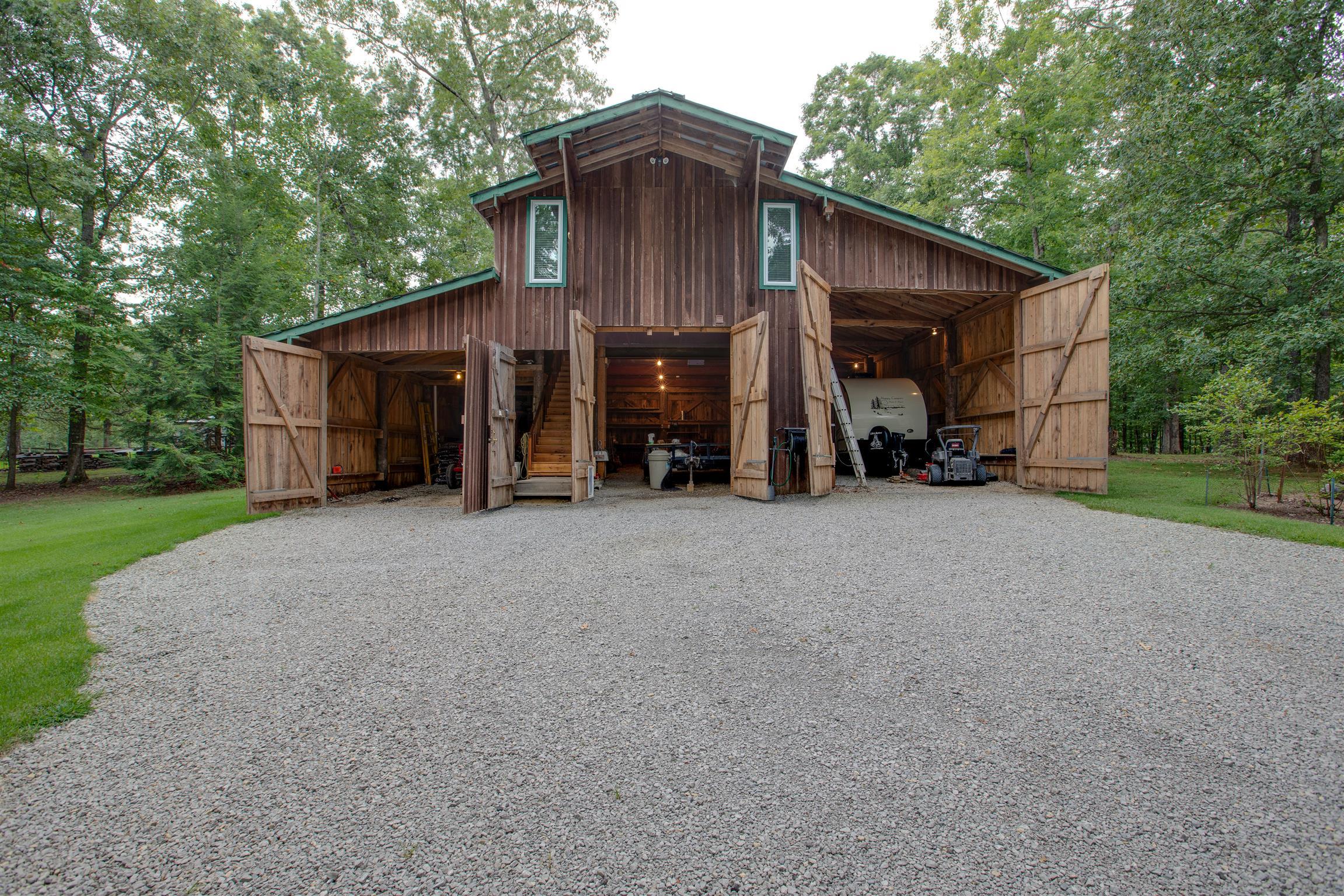 5745 Pinewood Road Franklin, TN 37064 - Photo 24 of 27 a view of a house with a big yard and large tree
