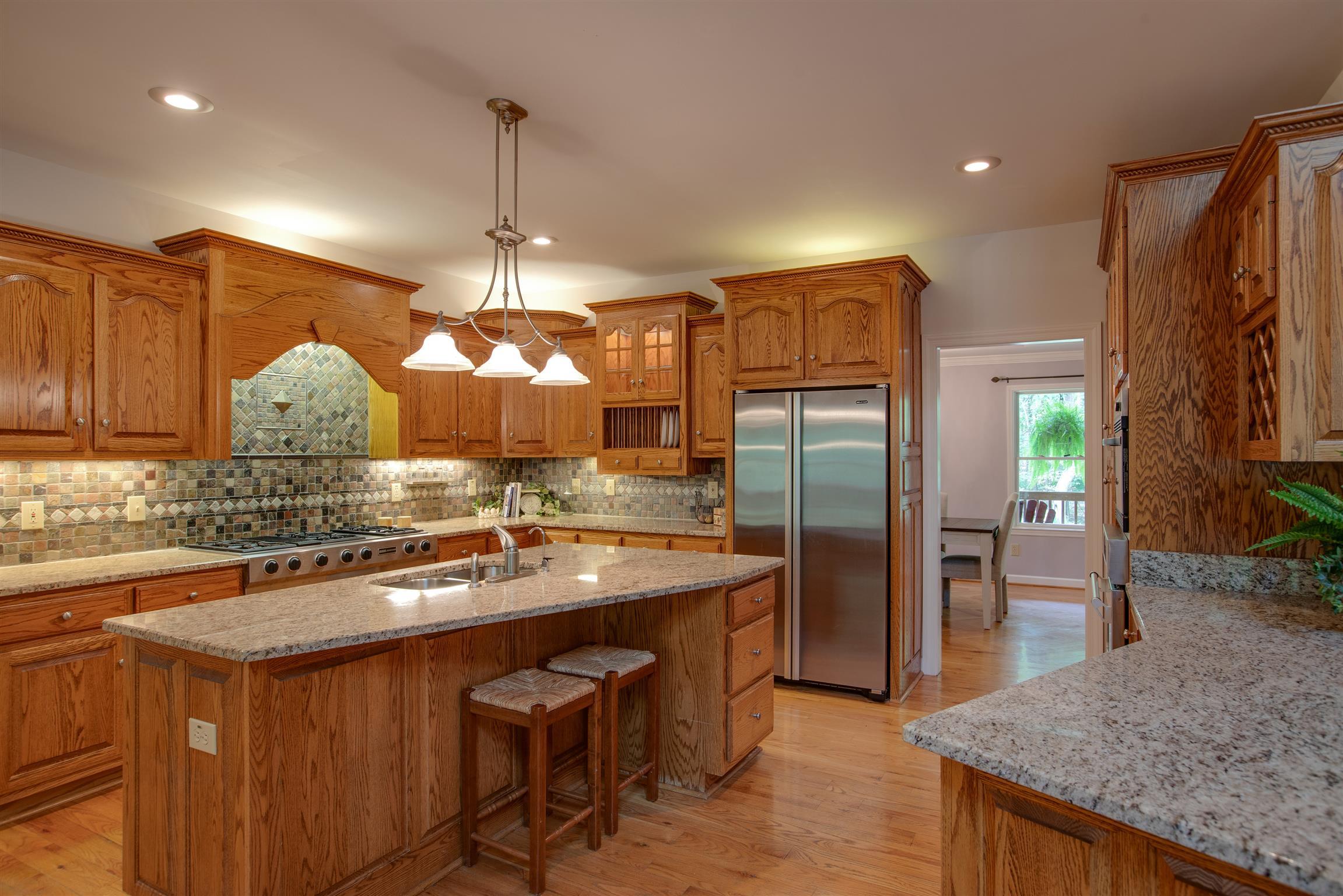 5745 Pinewood Road Franklin, TN 37064 - Photo 5 of 27 a kitchen with kitchen island granite countertop a sink stove and refrigerator