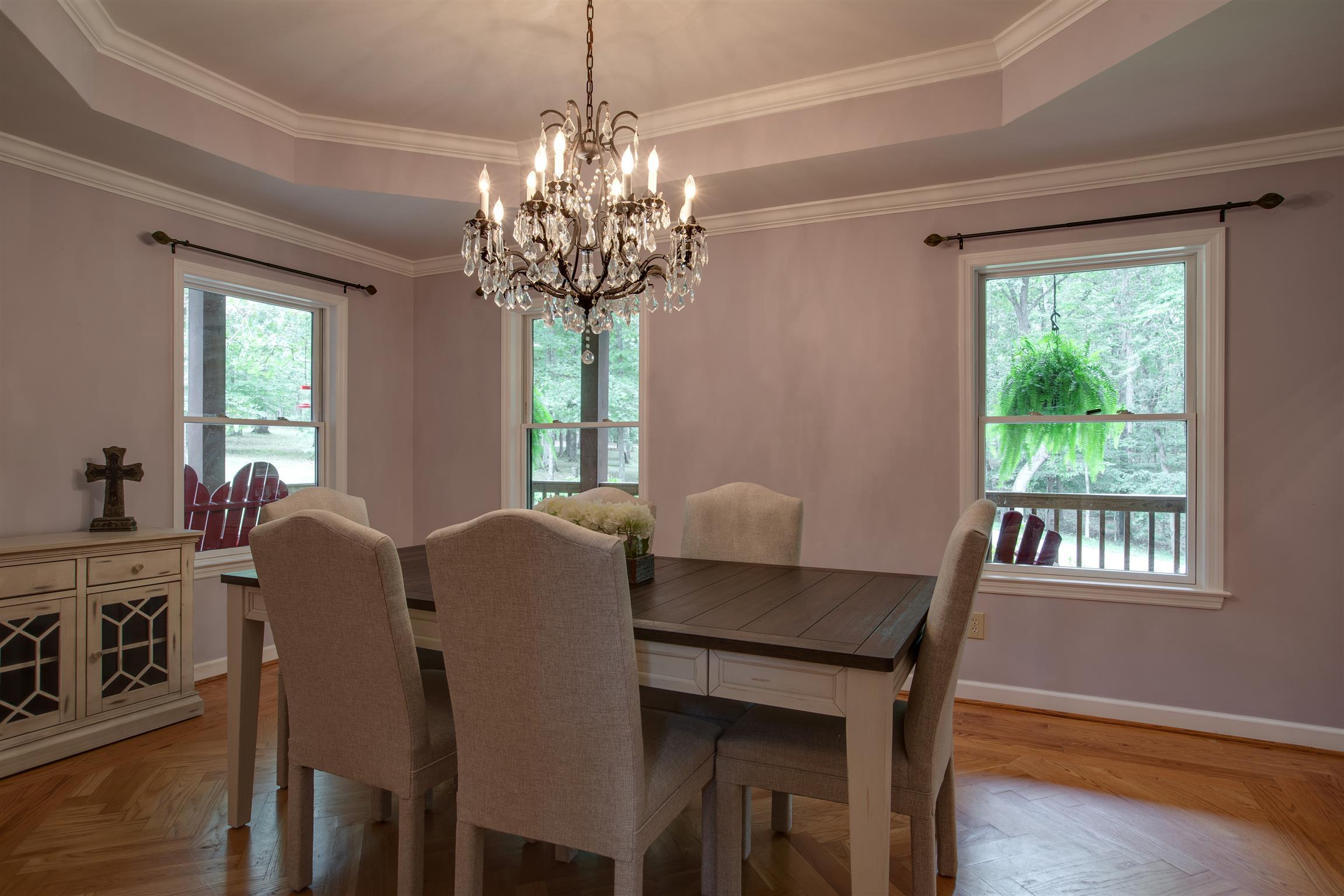 5745 Pinewood Road Franklin, TN 37064 - Photo 9 of 27 a dining room with furniture a chandelier and wooden floor