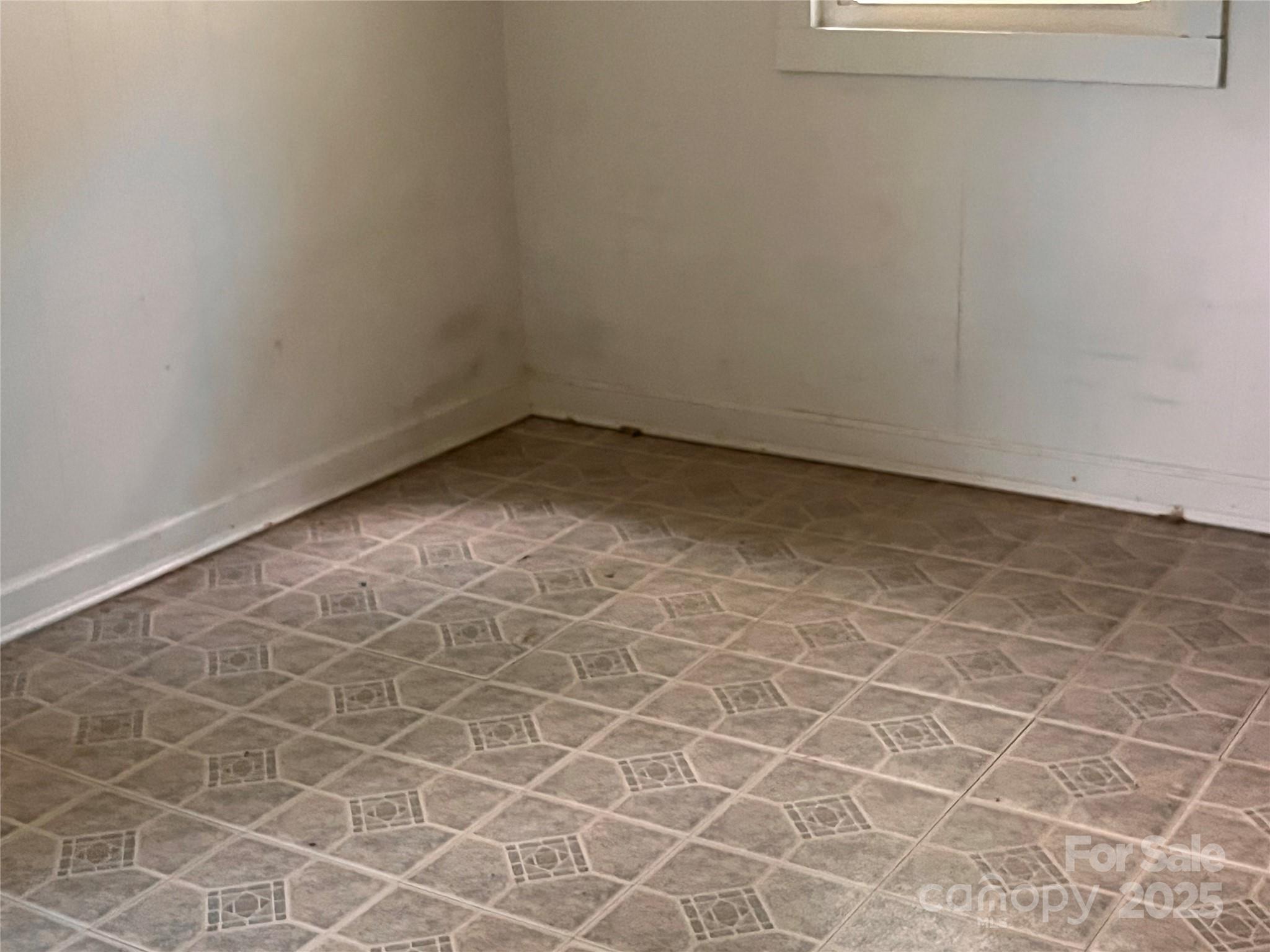 1147 Old Linville Road Marion, NC 28752 - Photo 22 of 27 an empty room with a window