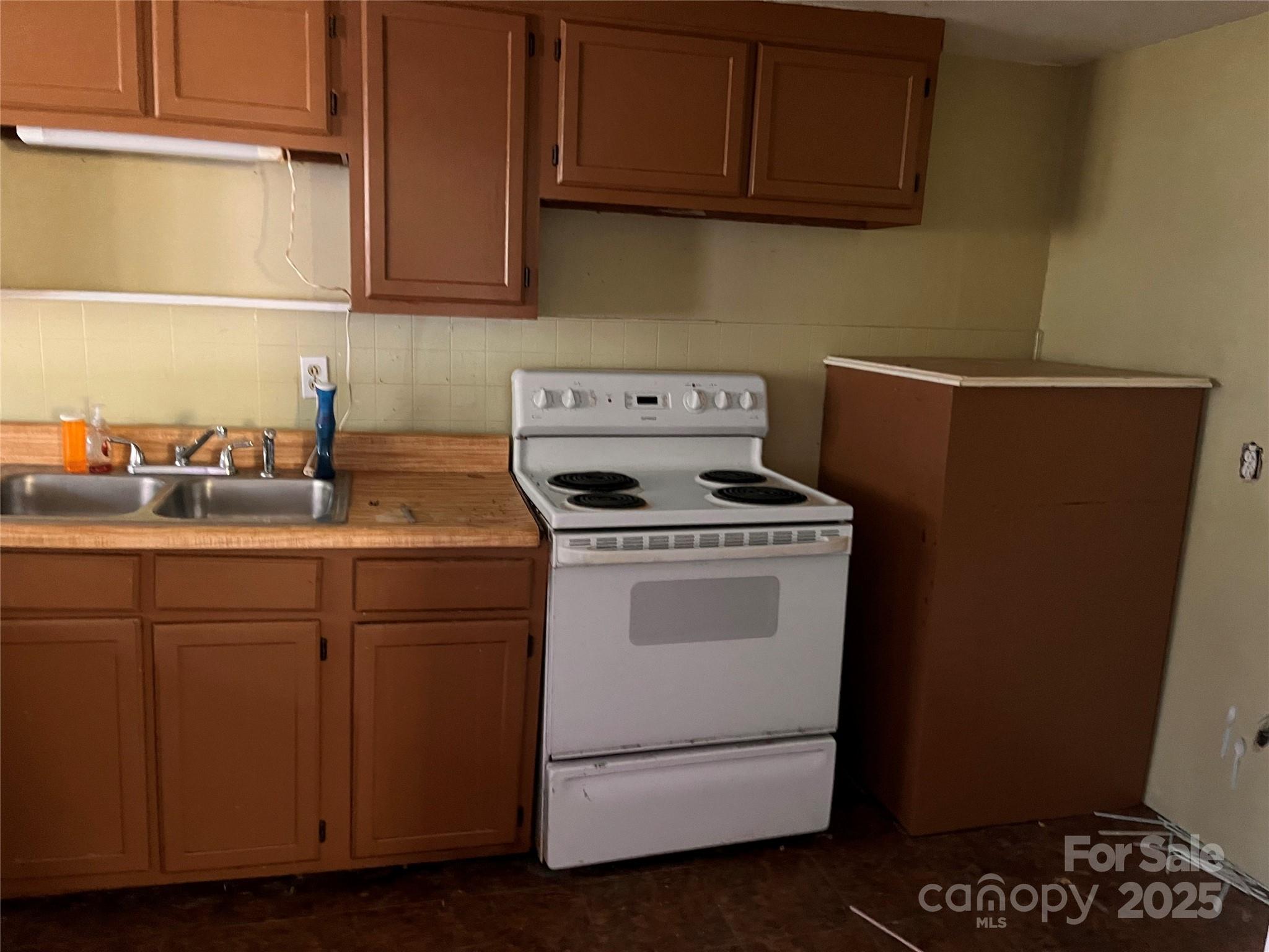 1147 Old Linville Road Marion, NC 28752 - Photo 23 of 27 a kitchen with cabinets appliances and a sink