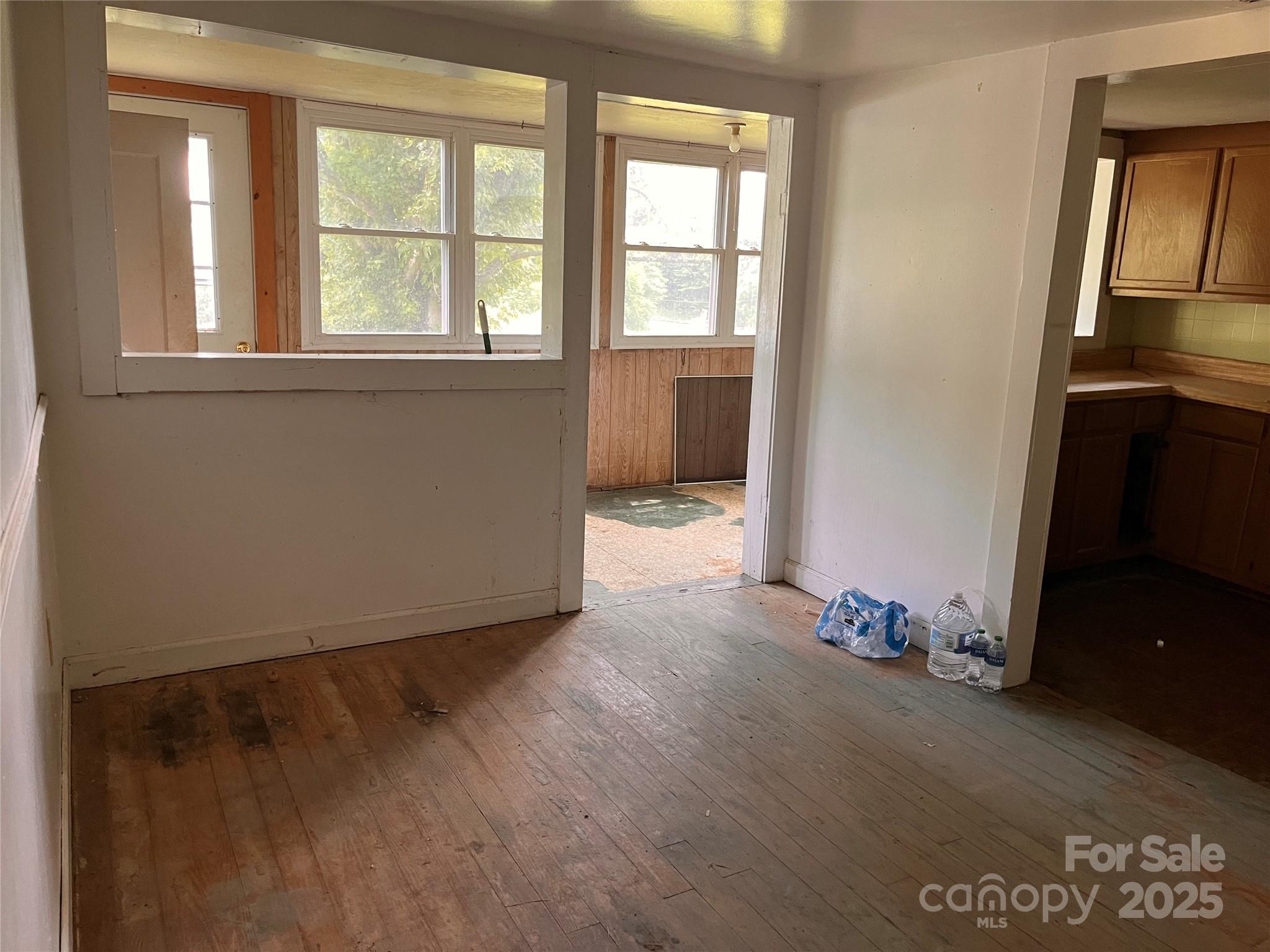 1147 Old Linville Road Marion, NC 28752 - Photo 24 of 27 an empty room with wooden floor and windows