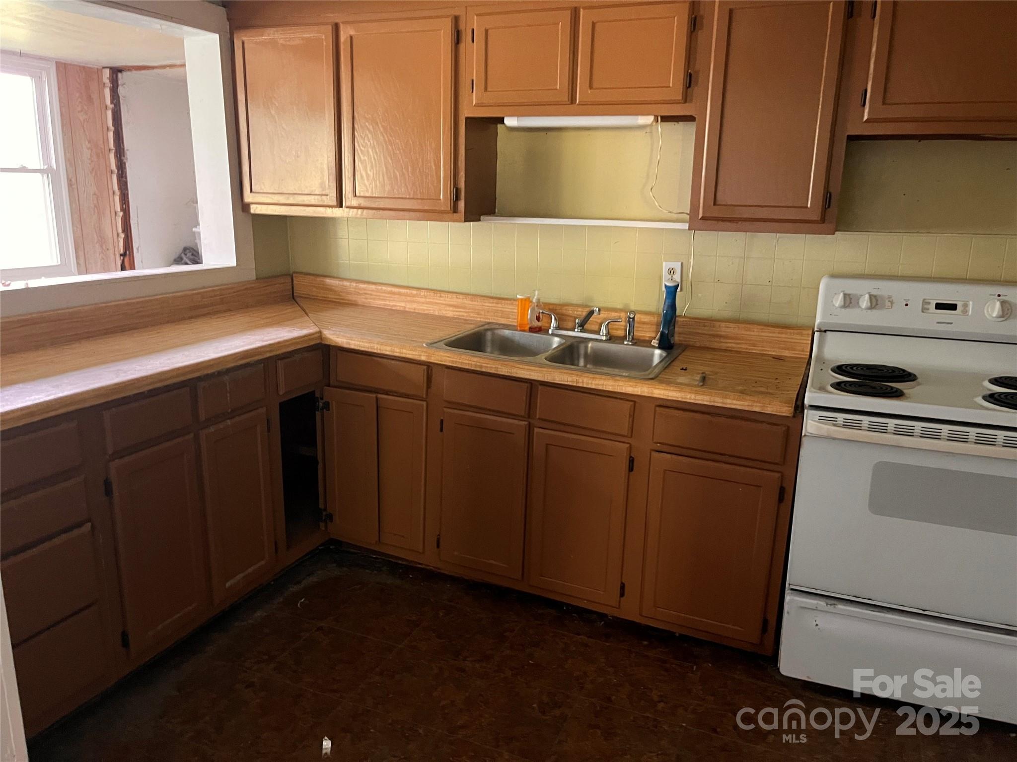 1147 Old Linville Road Marion, NC 28752 - Photo 27 of 27 a kitchen with a sink stove and cabinets