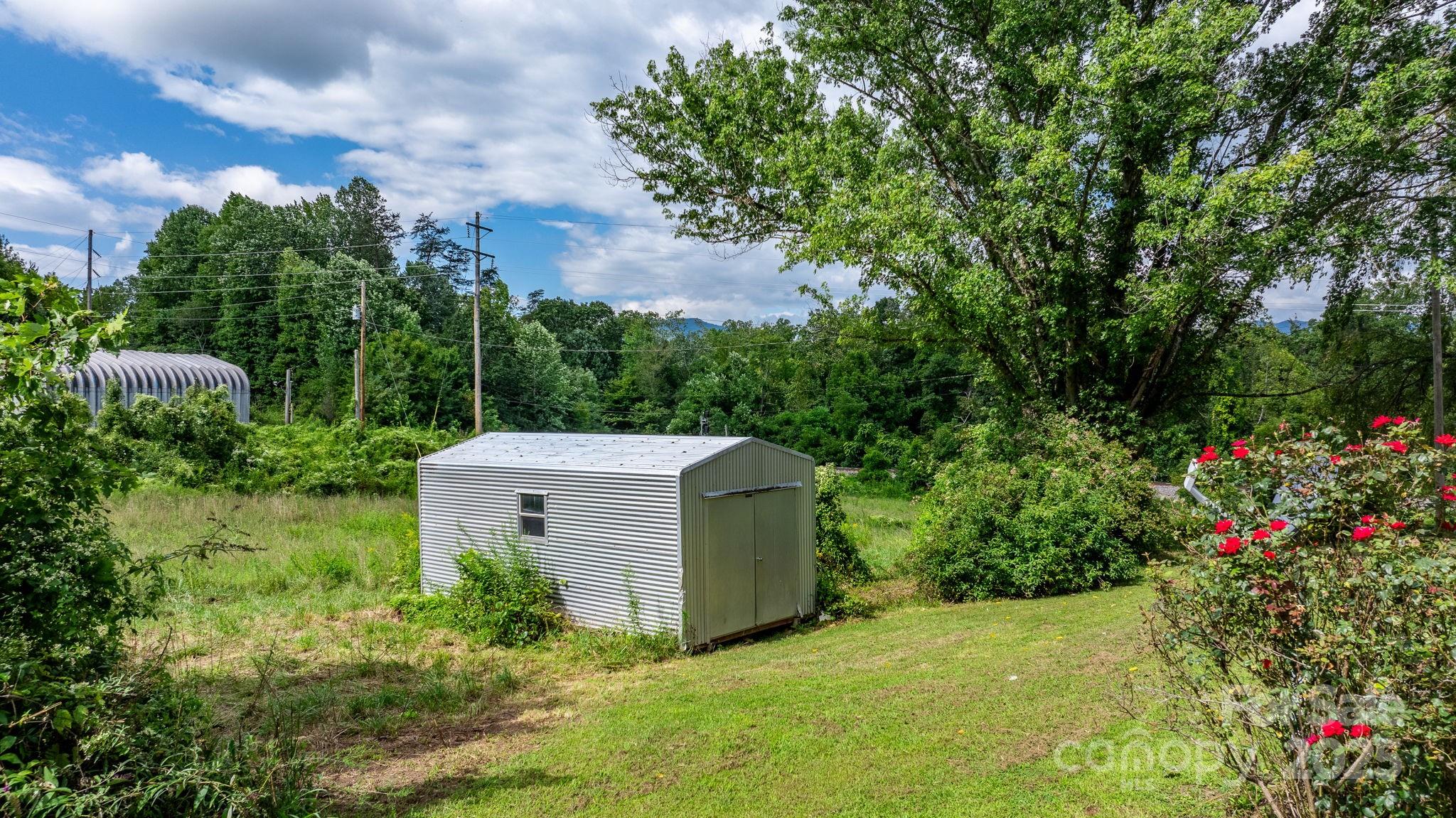 1147 Old Linville Road Marion, NC 28752 - Photo 5 of 27 a view of a garden with a house in the background