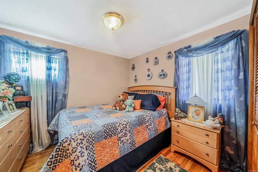 8 Brenner Road Coram, NY 11727 - Photo 17 of 43 a bedroom with a bed and a dresser in it