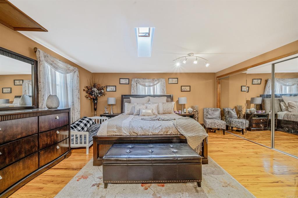 8 Brenner Road Coram, NY 11727 - Photo 19 of 43 a living room with furniture and wooden floor