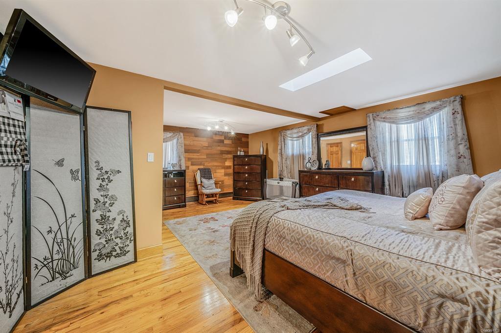 8 Brenner Road Coram, NY 11727 - Photo 20 of 43 a bedroom with a large bed and a dresser