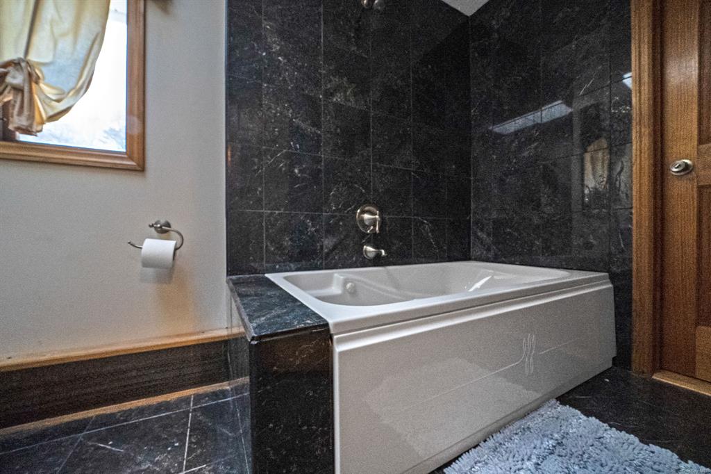8 Brenner Road Coram, NY 11727 - Photo 24 of 43 a bathroom with a bathtub