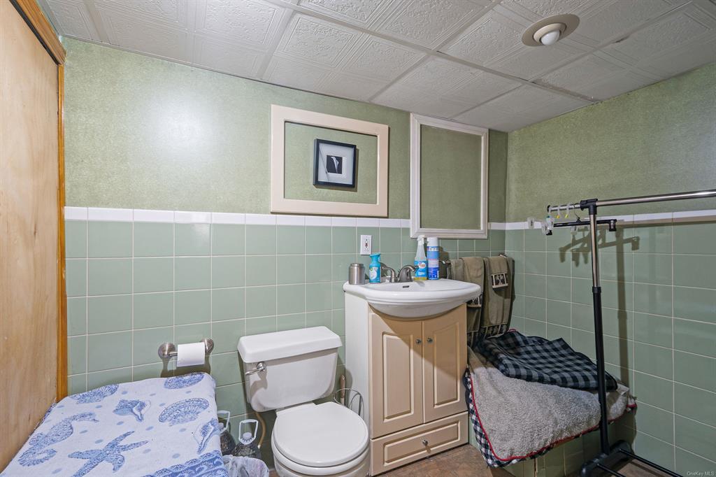8 Brenner Road Coram, NY 11727 - Photo 28 of 43 a bathroom with a toilet sink and shower
