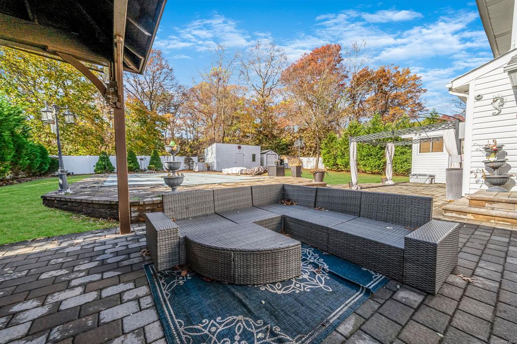 8 Brenner Road Coram, NY 11727 - Photo 33 of 43 a view of a patio with couches and a fire pit