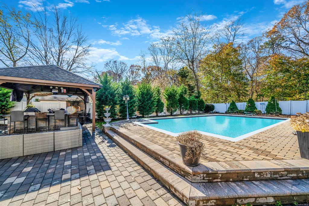 8 Brenner Road Coram, NY 11727 - Photo 37 of 43 a view of a swimming pool with a patio and a yard