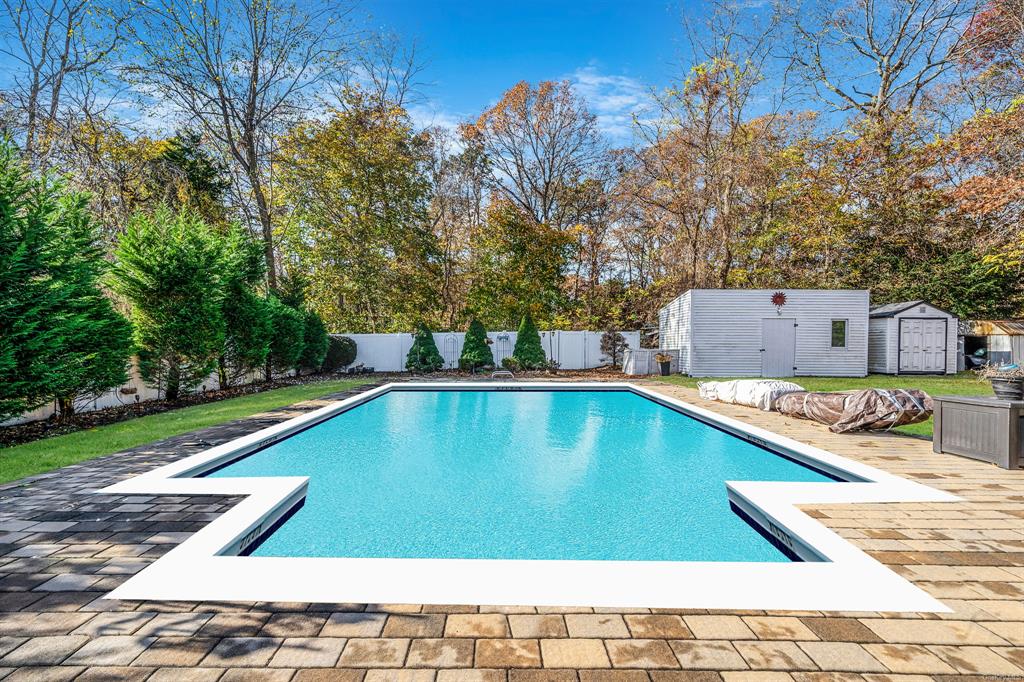 8 Brenner Road Coram, NY 11727 - Photo 39 of 43 a view of a swimming pool with a lounge chairs
