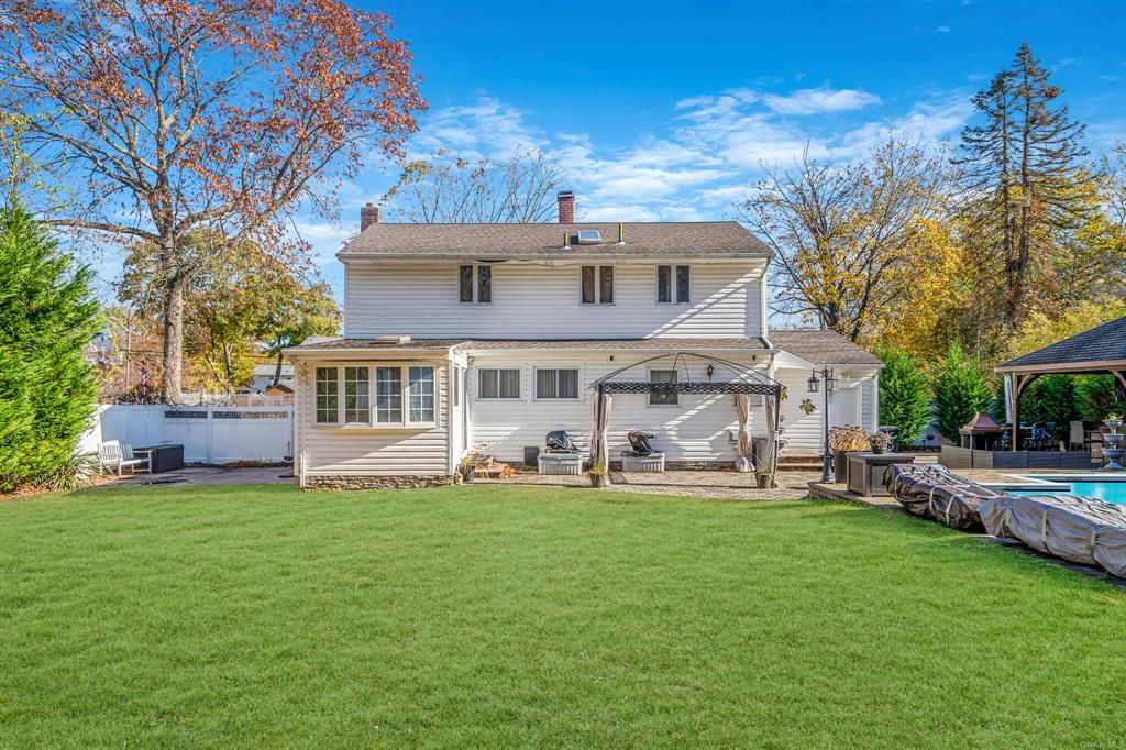 8 Brenner Road Coram, NY 11727 - Photo 41 of 43 a front view of a house with a garden and trees