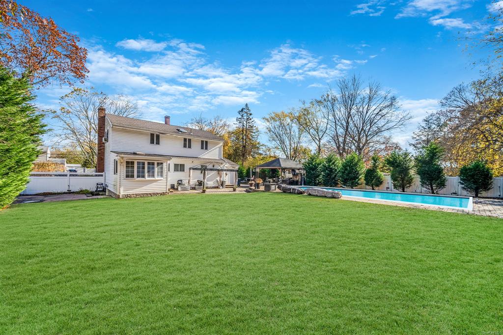 8 Brenner Road Coram, NY 11727 - Photo 42 of 43 a view of a house with a big yard