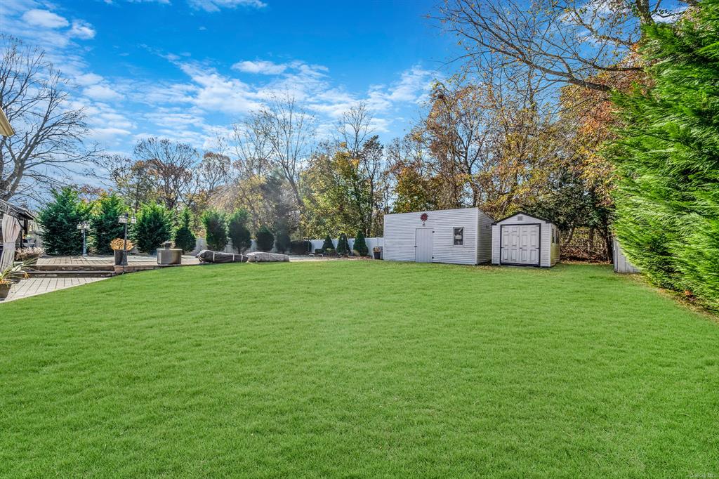 8 Brenner Road Coram, NY 11727 - Photo 43 of 43 a view of a house with backyard and trees