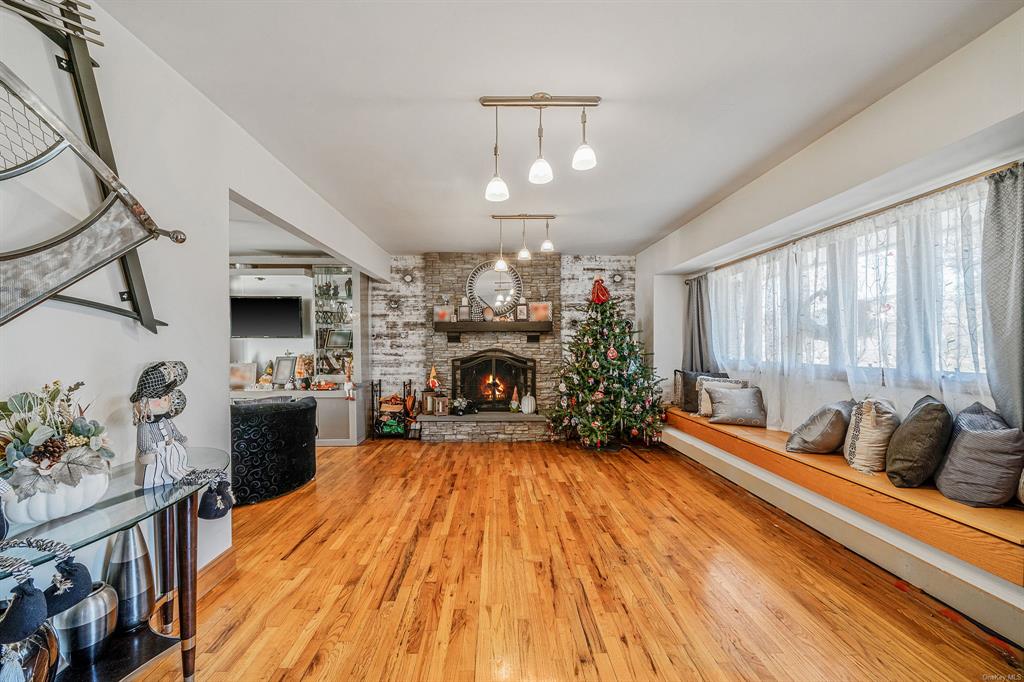 8 Brenner Road Coram, NY 11727 - Photo 6 of 43 a living room with fireplace furniture and a large window