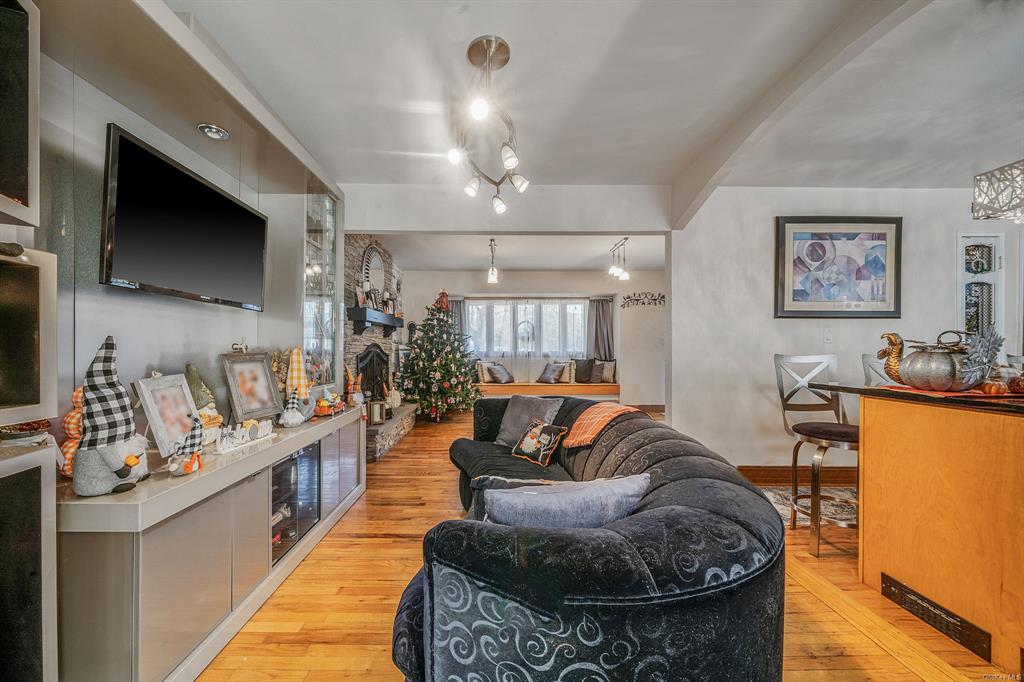 8 Brenner Road Coram, NY 11727 - Photo 10 of 43 a living room with furniture and a flat screen tv