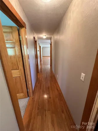 a view of gallery with wooden floor