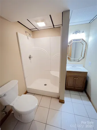 a bathroom with a toilet and a shower