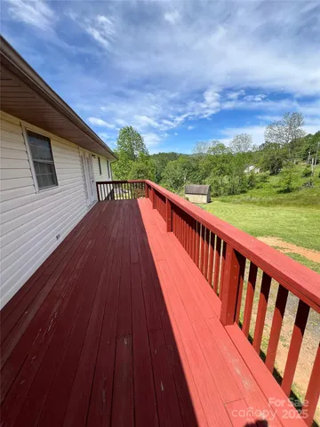 a view of balcony with wooden floor and fence