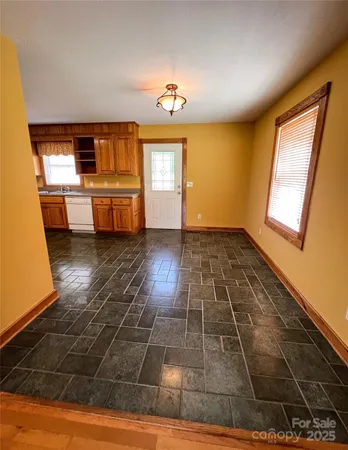a view of a kitchen with a sink and a window