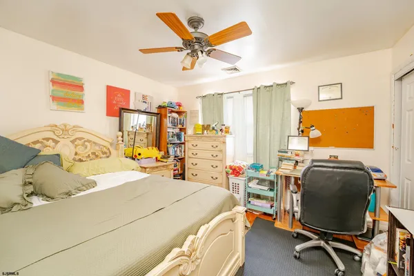 a bedroom with a bed and a desk