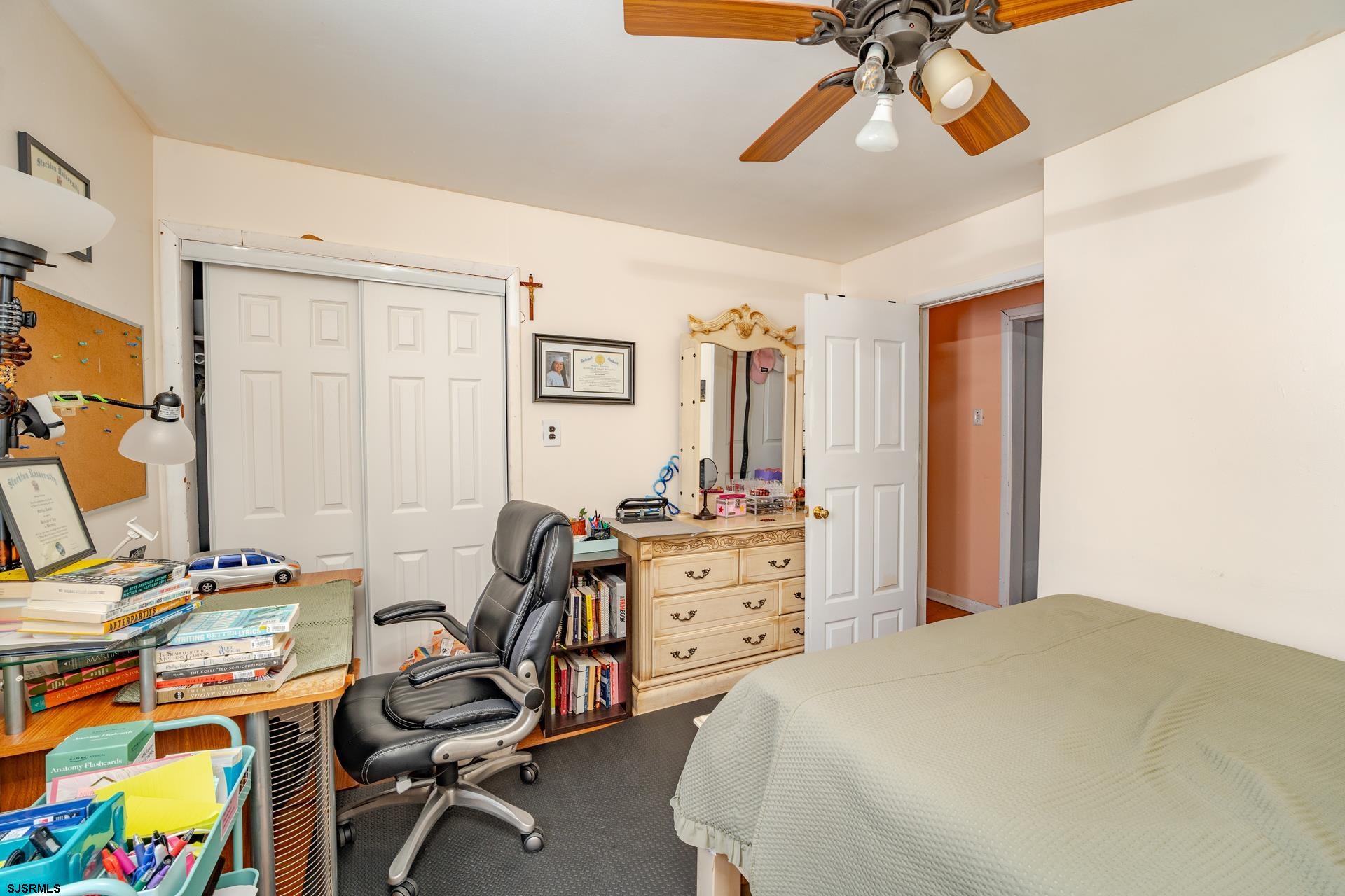 6529 Delilah Road Egg Harbor Township, NJ 08234 - Photo 20 of 70 a bedroom with a bed and a chandelier