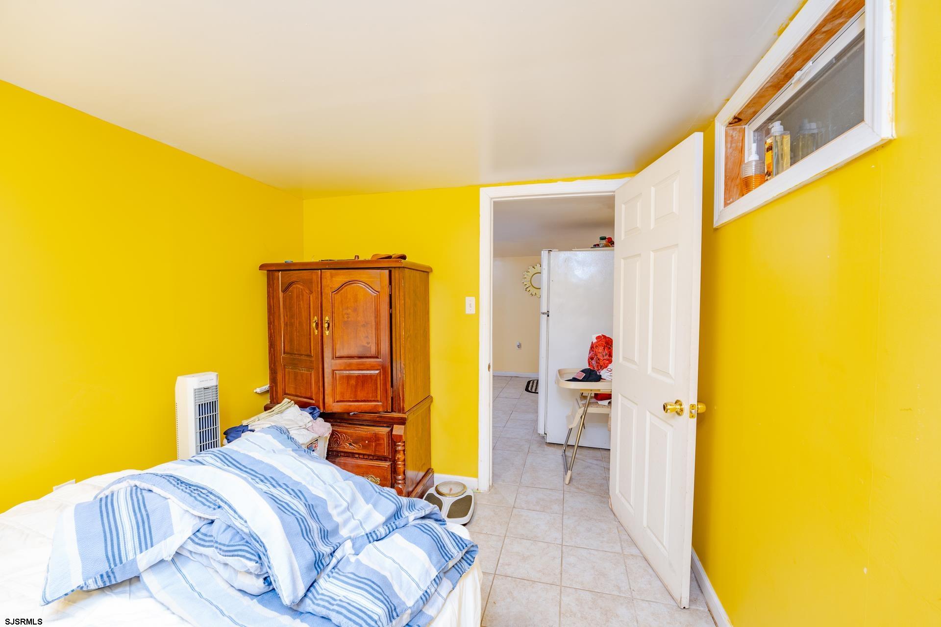 6529 Delilah Road Egg Harbor Township, NJ 08234 - Photo 26 of 70 a bedroom with a bed and a lamp